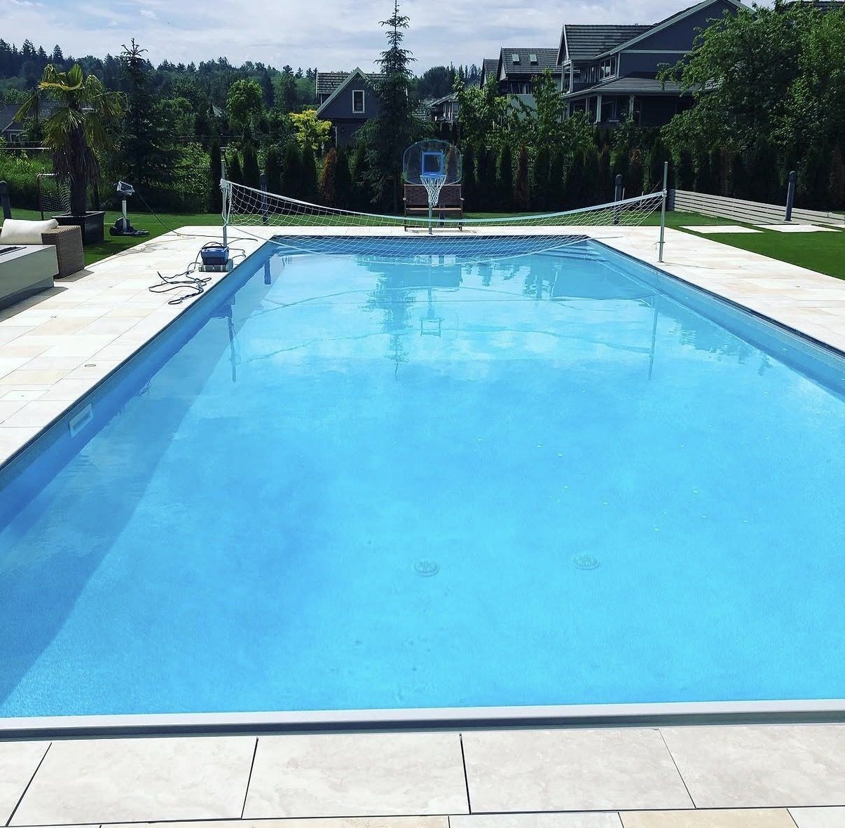 Rectangular family pool with volleyball net, clean and ready for summer