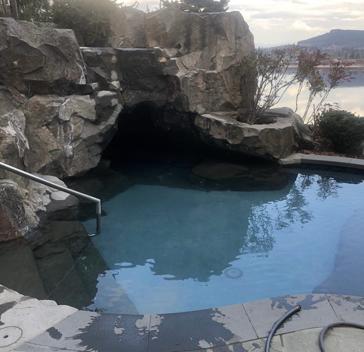 Custom pool with rock cave feature maintained year round