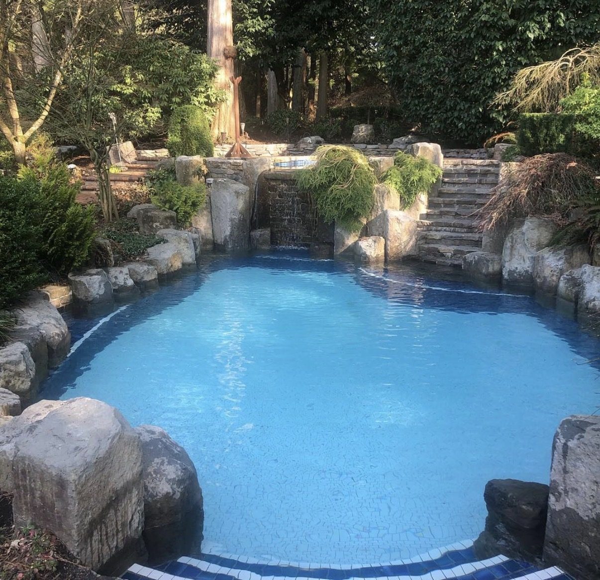 Natural rock grotto pool with waterfall maintained in White Rock BC