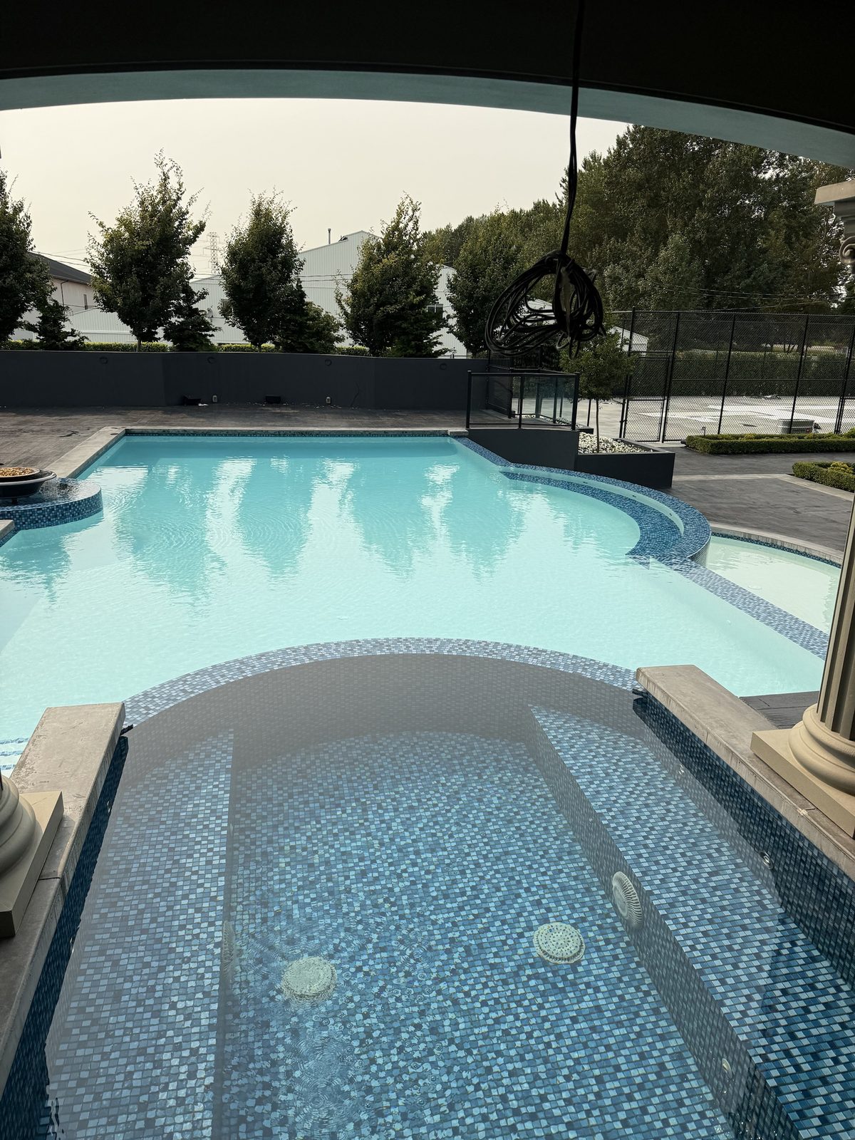 Raised tile spa overlooking the main pool from under the loggia